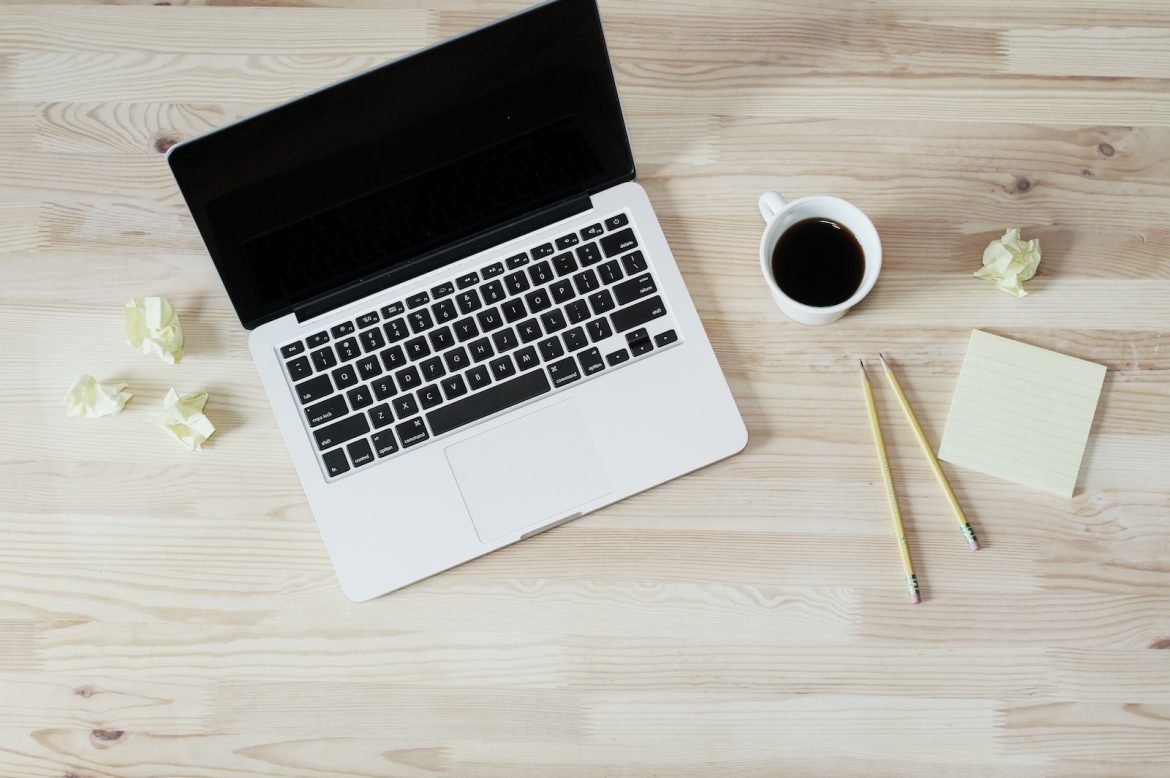 ordinateur café et stylos sur un bureau